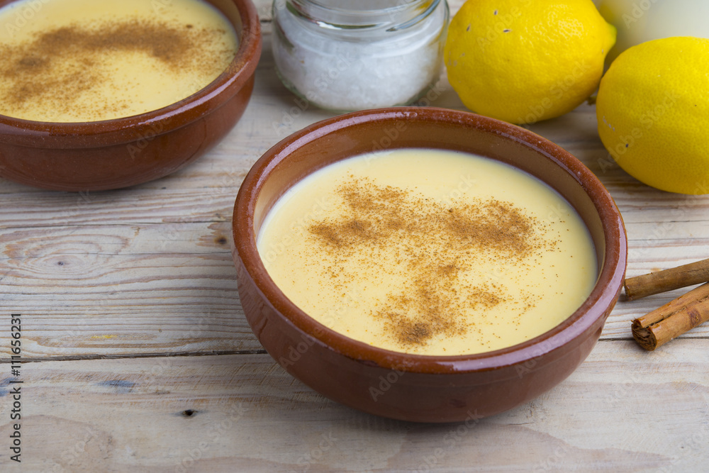 Traditional creme brulee on ceramic dish on wooden table Traditional creme brulee on ceramic dish on wooden table