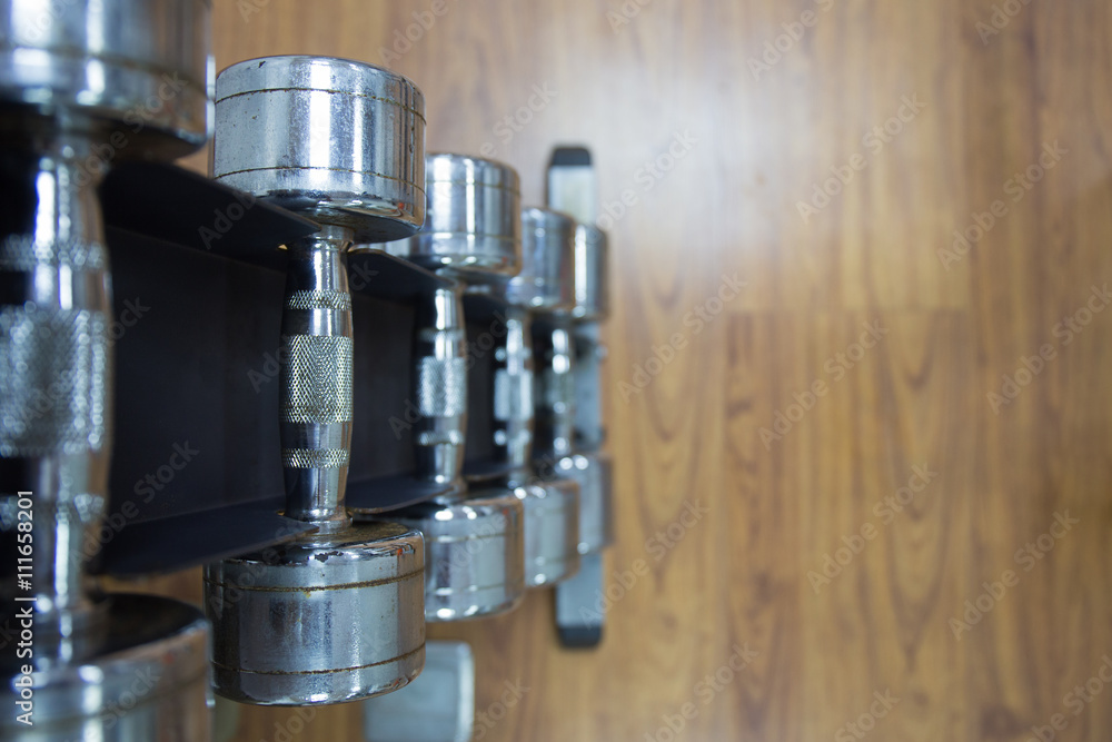 dumbbells on rack in on wood floor workout room dumbbells on rack in on wood floor workout room