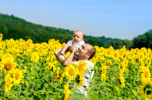 Father with son on the sunflower field © sushytska