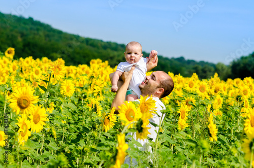 Father with son on the sunflower field