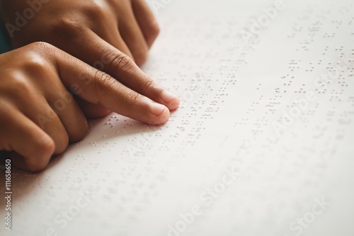 Child using braille to read photo
