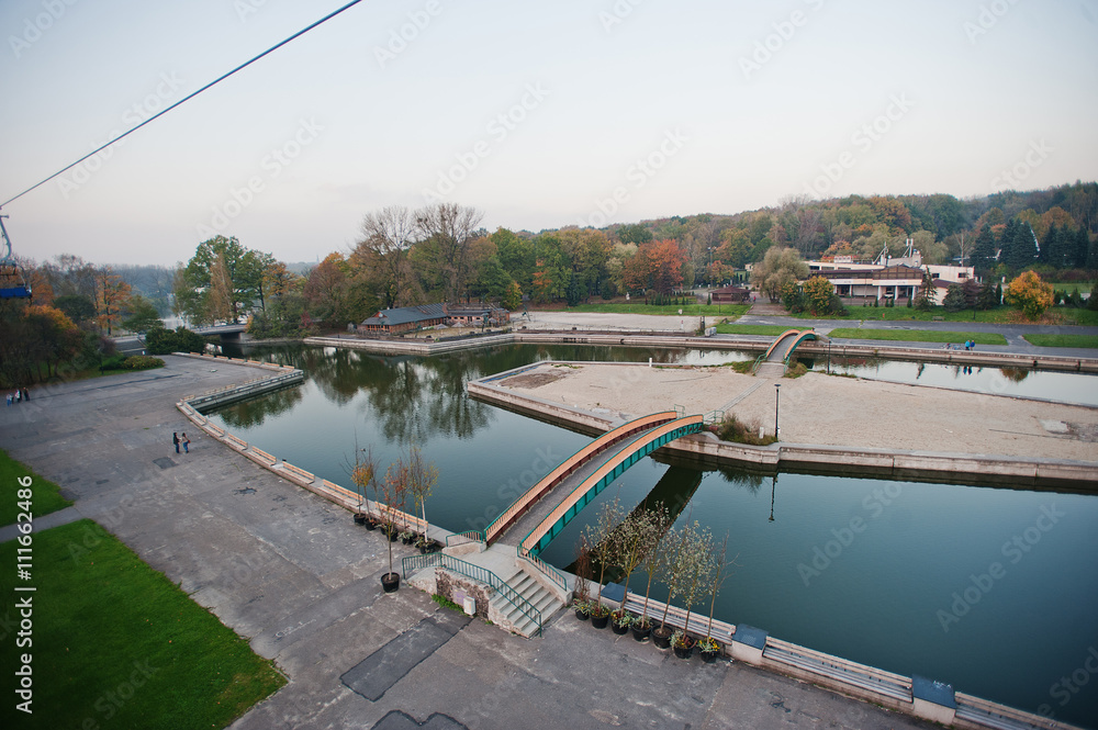 Aerial view from cable car of park and lake with bridges at Uppe