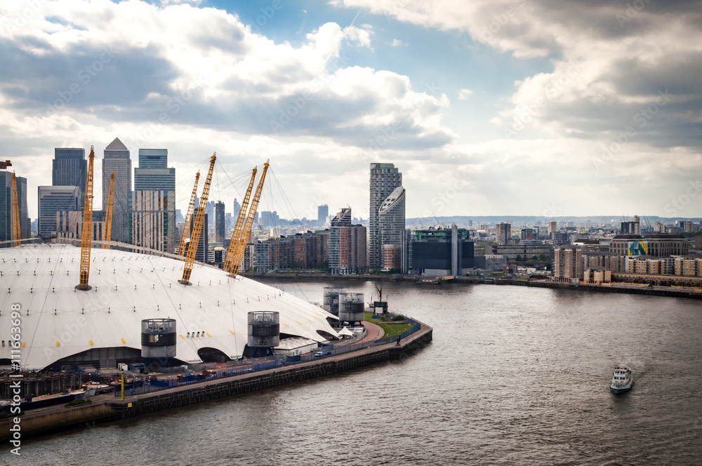 Aerial view of River Thames, North Greenwich and the Docklands on a cloudy day in London, England, UK