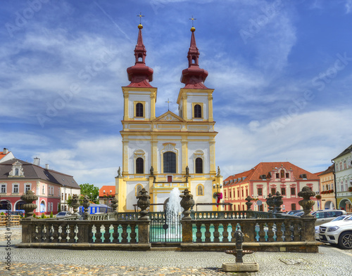 Kadan - The main square, fountain and Church of the Exaltation of the Holy Cross. The church is located on the site of an original Gothic church from the 13th century. photo