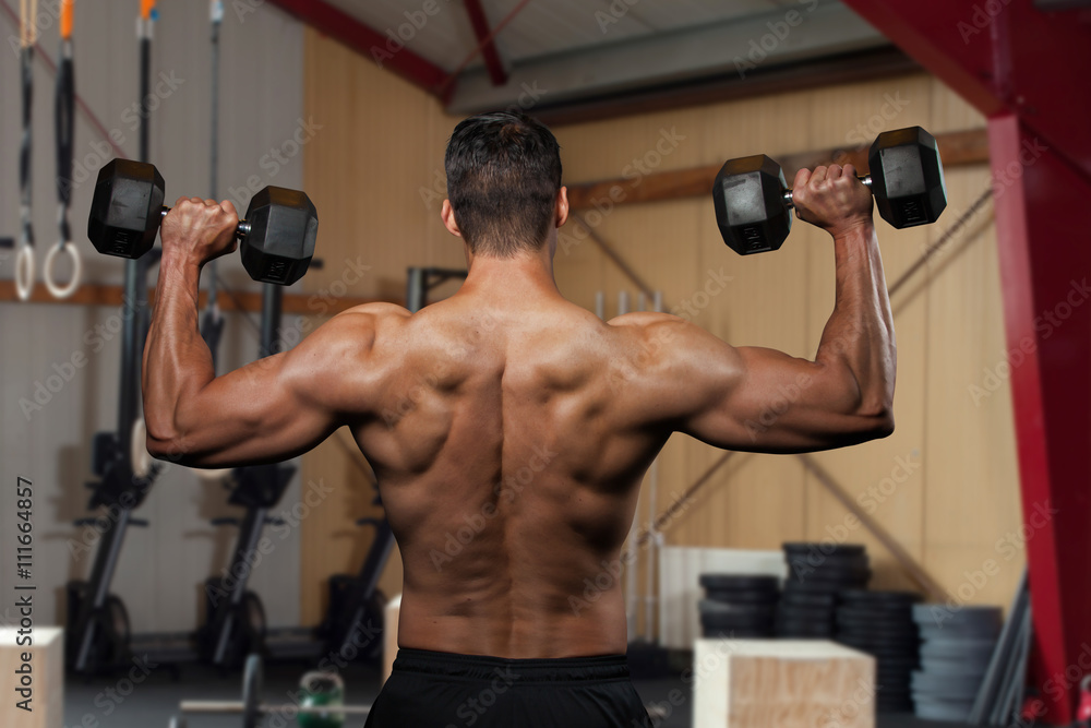 Man holding a dumbbell doing a fitness workout Man holding a dumbbell doing a fitness workout