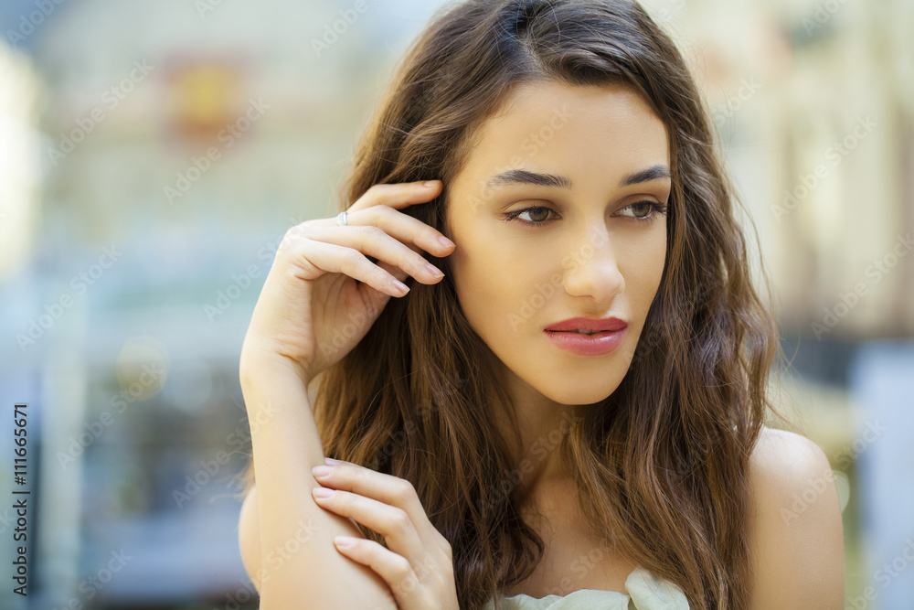 Portrait close up of young beautiful brunette woman in beige dre Portrait close up of young beautiful brunette woman in beige dre