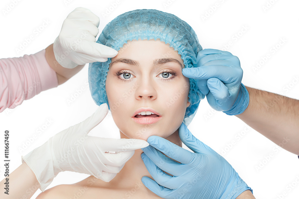 Plastic surgery concept. Doctor hands in gloves touching woman face Plastic surgery concept. Doctor hands in gloves touching woman face