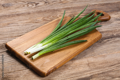 fresh spring green onions on a cutting board kitchen