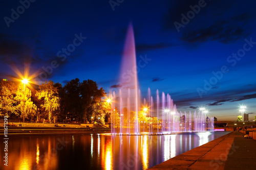 illuminated in different colors at night fountains Plotinka. Summer Yekaterinburg downtown.