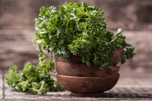 tied fresh parsley on wooden surface, healthy food