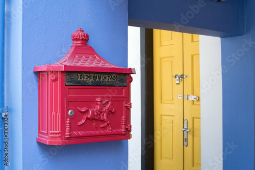 Red mailbox, yellow door and blue wall