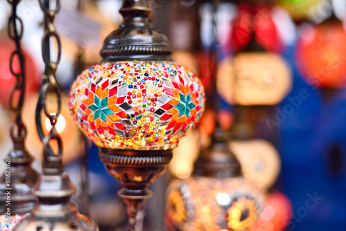 Turkish or oriental lamps on a bazaar with selective focus on the foreground. Multicolored lamps or lanterns with copy space.