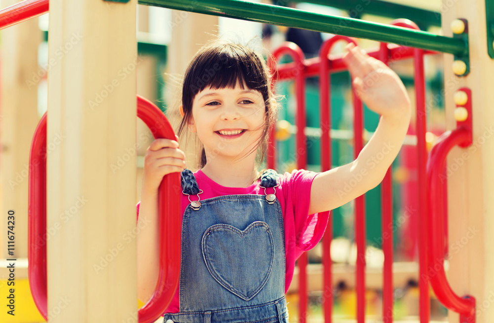 Obraz premium happy little girl climbing on children playground