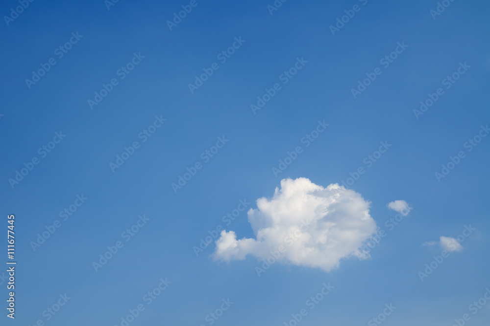 One white heap cloud against a blue sky. One white heap cloud against a blue sky.