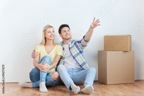couple with boxes moving to new home and dreaming © Syda Productions