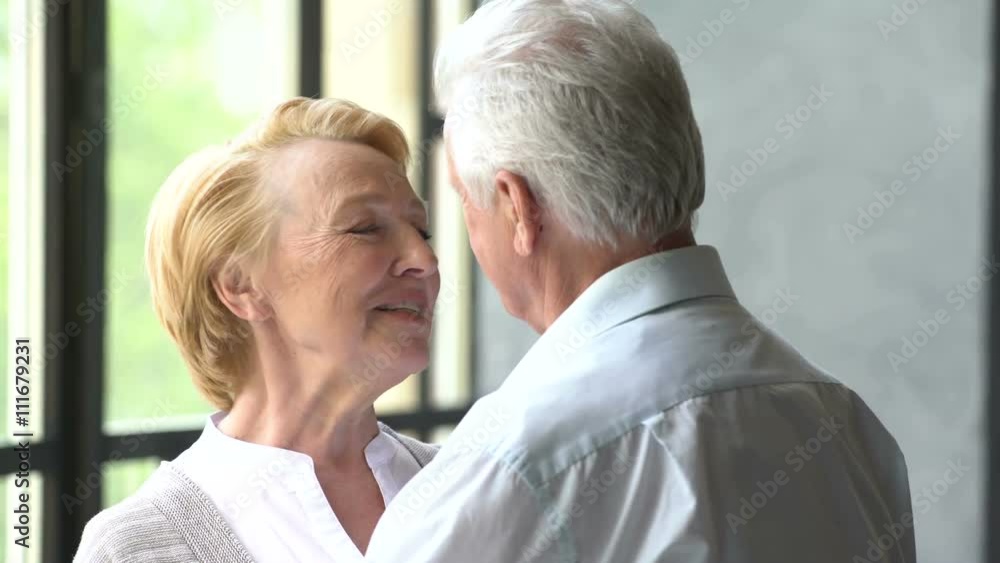 beautiful and happy elderly couple talk and smile. woman looking at the camera beautiful and happy elderly couple talk and smile. woman looking at the camera