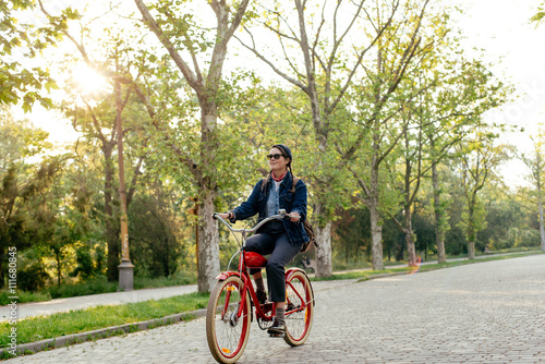 female riding vintage bicycle in park 