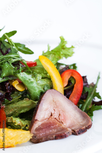 Fresh salad with ham and greens