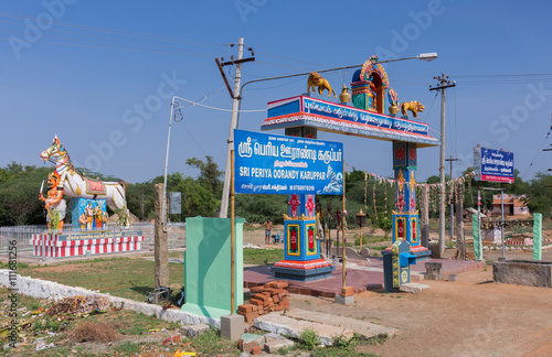 Chettinad, India - October 16, 2013: Overview of the Ayyanar sanctuary at Pilivalam village. Ayyanar as the village protector on shrine and with his horse. Oorandy Karuppar is local Ayyanar.