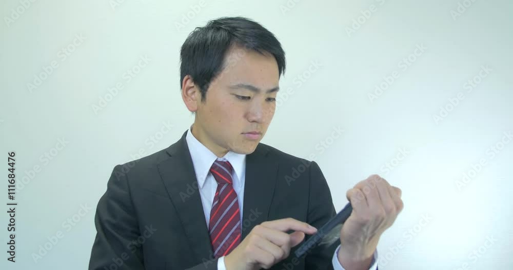 Japanese young business man calculating costs confused face Japanese young business man calculating costs confused face