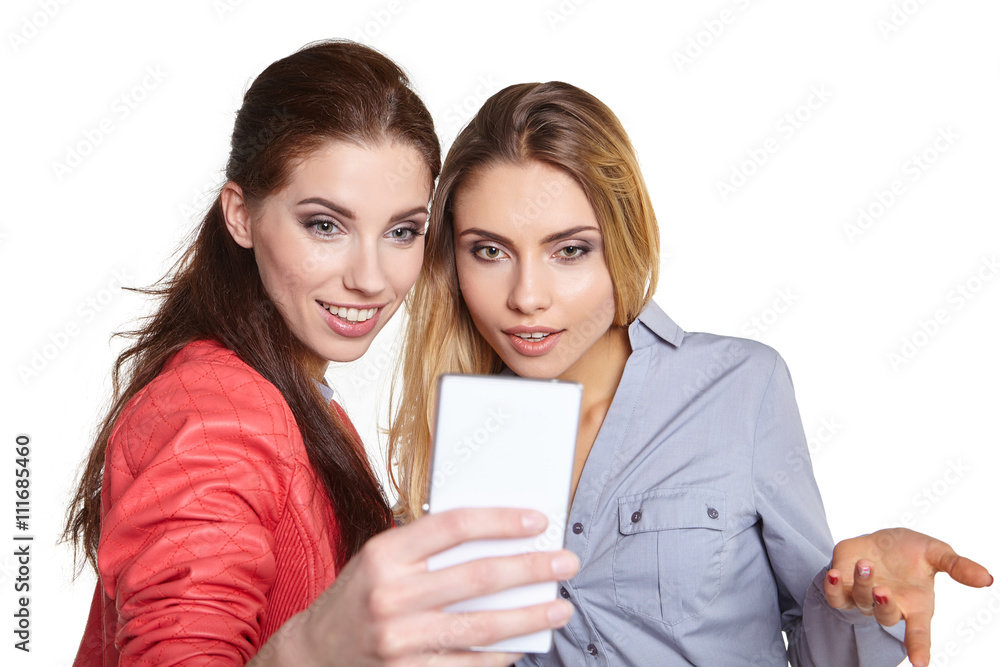 Two women sharing social media in a smart phone Two women sharing social media in a smart phone