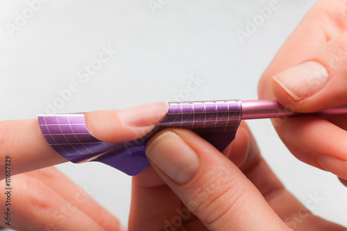 Manicure. Master make nail extension. Finger closeup
