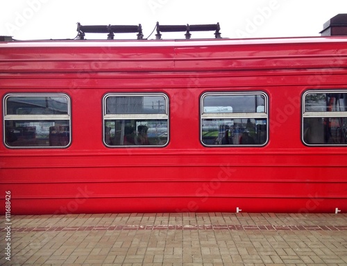 Detail of red train at platform of train station