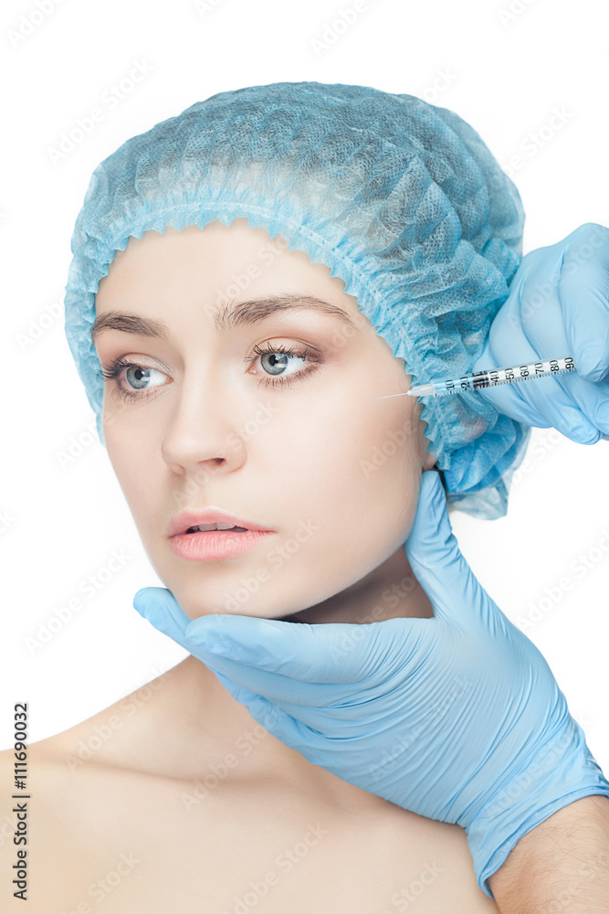 Attractive woman at plastic surgery with syringe in her face Attractive woman at plastic surgery with syringe in her face