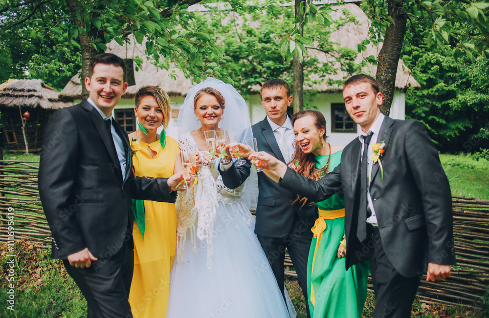 Groomsman and bridesmaid drinking champagne on wedding party