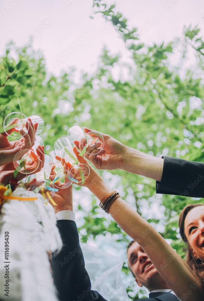 Groomsman and bridesmaid drinking champagne on wedding party