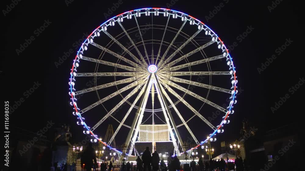 Silhouettes of many people coming to amusement park for observation wheel ride Silhouettes of many people coming to amusement park for observation wheel ride