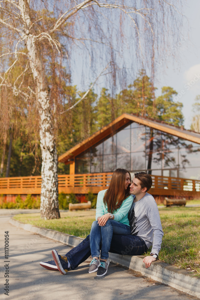 Cheerful couple standing in front of new house Cheerful couple standing in front of new house