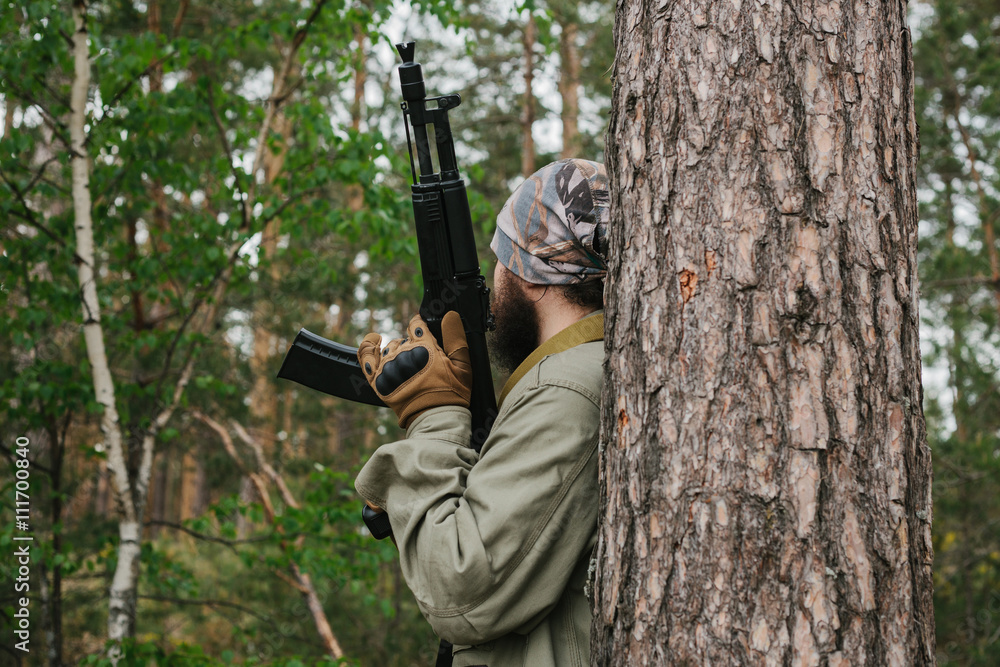 Naklejka premium Armed man in a zone of armed conflict
