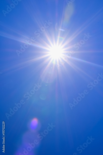 Real sunshine flare in blue sky