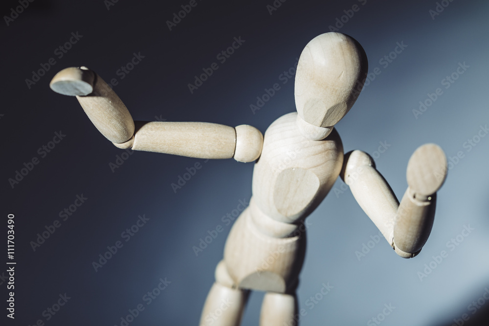 Wooden mannequin dummy on a blue background Wooden mannequin dummy on a blue background