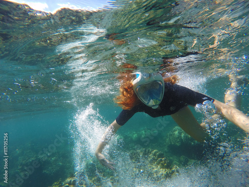 Snorkeling woman making bubbles under water in coral reef © Elya.Q