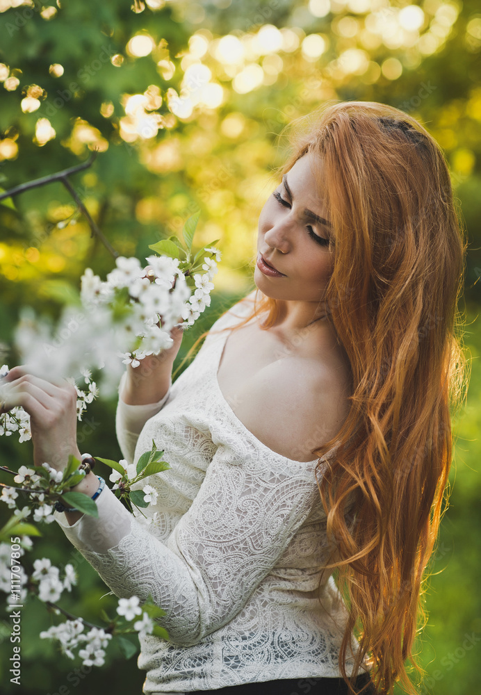 Portrait of a girl admiring a Bush with flowers 6190. Portrait of a girl admiring a Bush with flowers 6190.