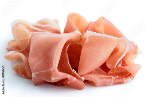Thinly sliced Prosciutto ham. Isolated on white.
