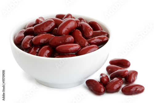 Фотография Red kidney beans in a dish in perspective. Isolated on white.