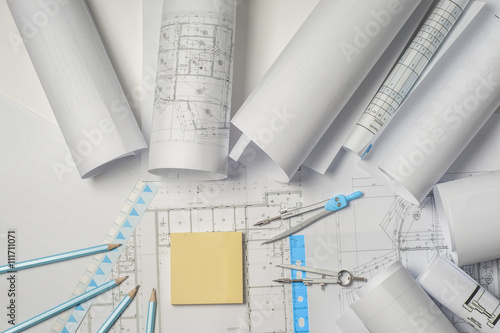 Workplace of architect - Architect rolls and plans. architectural plan,technical project drawing. Engineering tools view from the top. Construction background.