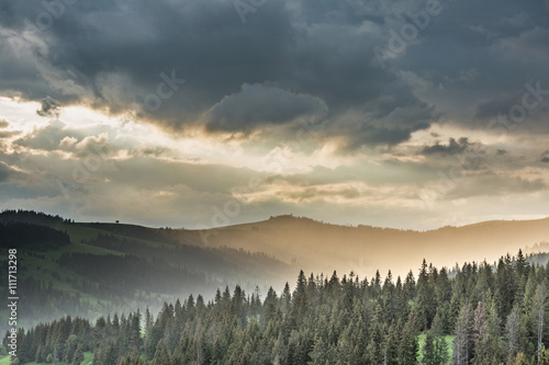 Storm clouds over mountains and the forest