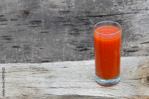 Tomato juice on wooden background