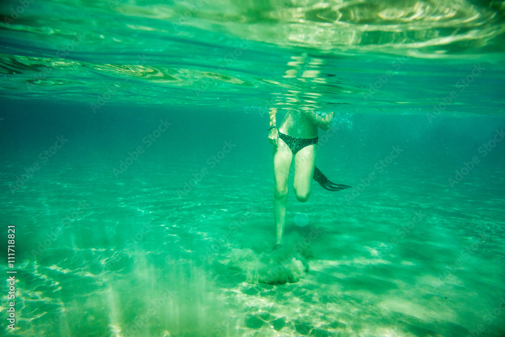 Underwater scene in Ionian sea, Zakynthos, Greece, with girls playing in the water