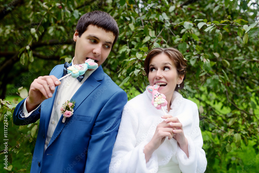 Wedding couple on the nature is hugging each other. Beautiful model girl in white dress. Man in suit. Beauty bride with groom. Female and male portrait. Woman with lace veil. Lady and guy outdoors Wedding couple on the nature is hugging each other. Beautiful model girl in white dress. Man in suit. Beauty bride with groom. Female and male portrait. Woman with lace veil. Lady and guy outdoors