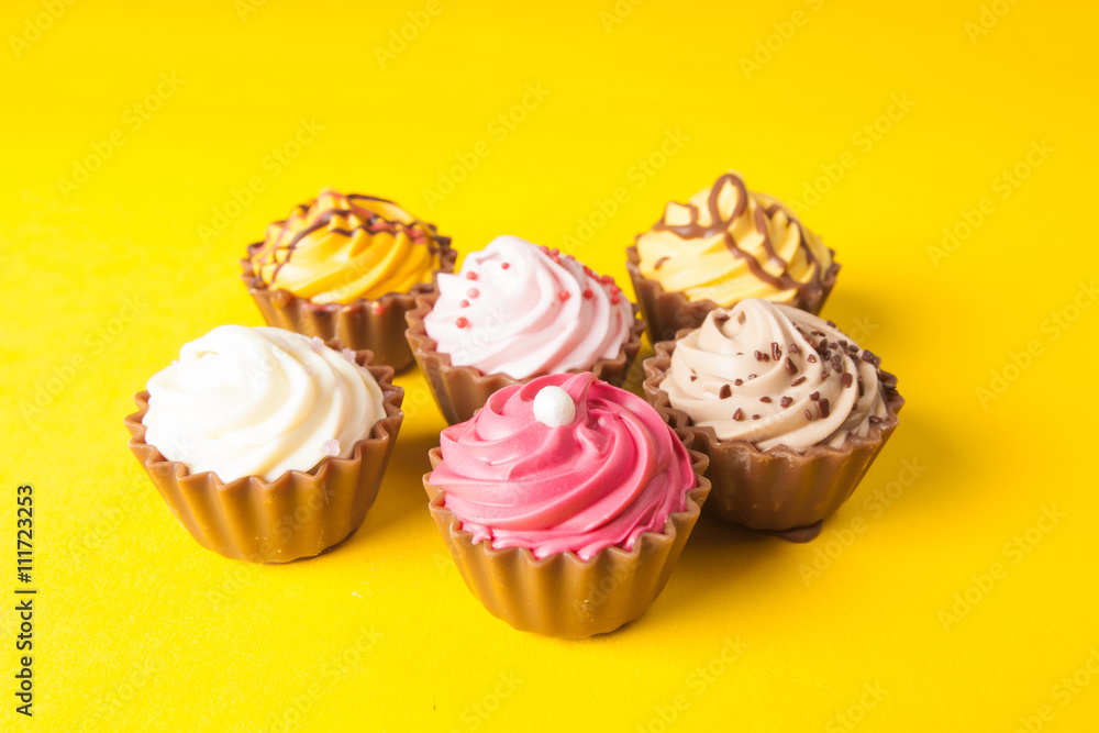 Chocolate cupcakes with yellow backgroud Chocolate cupcakes with yellow backgroud