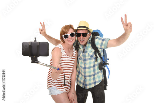 young attractive and chic American couple taking selfie photo with mobile phone isolated on white