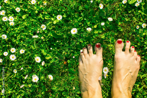 Feet in the green grass.