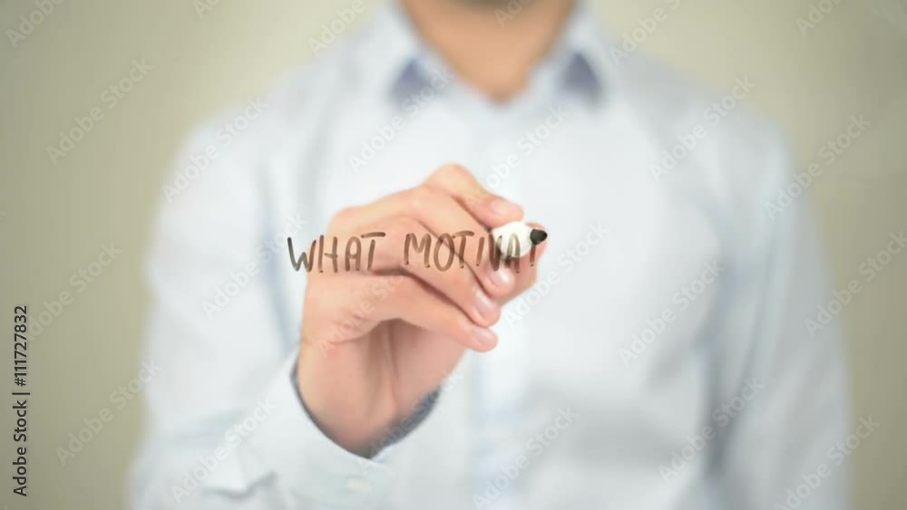 What Motivates You, Man Writing on Transparent Screen What Motivates You, Man Writing on Transparent Screen