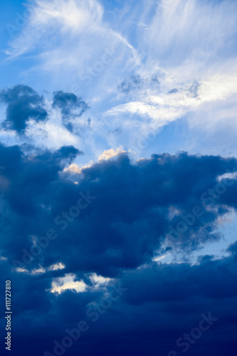 Clouds developing into a storm on a blue sky background