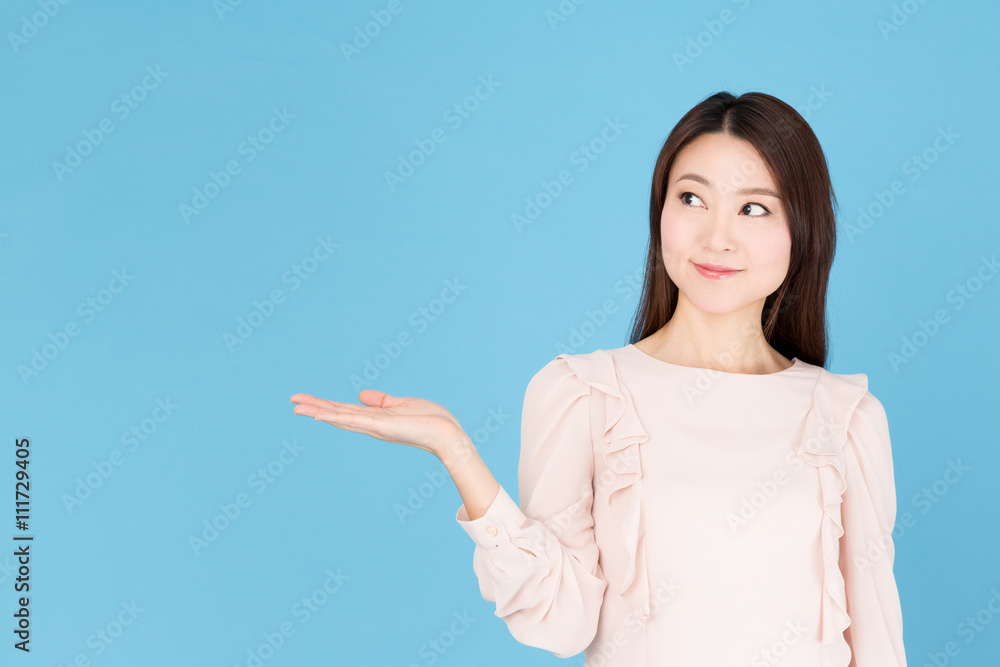 portrait of asian woman showing isolated on blue background portrait of asian woman showing isolated on blue background